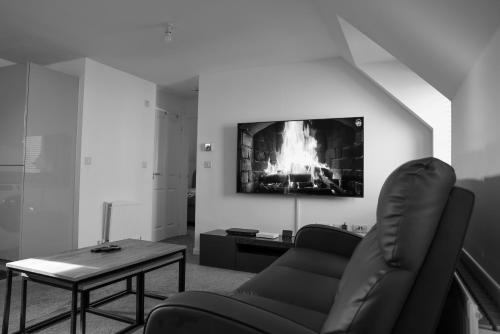 a living room with a couch and a table at Stunning Two-Bedroom Apartment at A3REE, Free Parking, near Cribbs Causeway Mall in Bristol