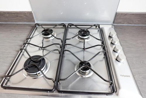 a white stove top with four burners on it at Stunning Two-Bedroom Apartment at A3REE, Free Parking, near Cribbs Causeway Mall in Bristol