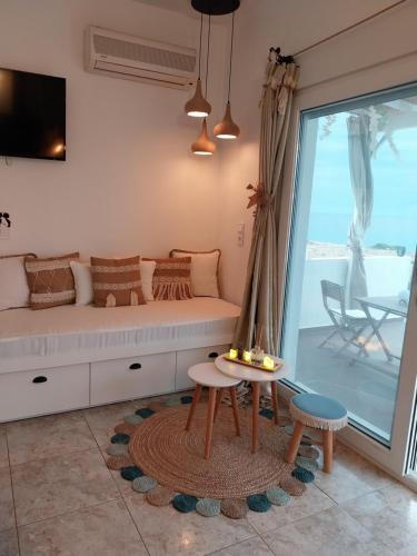 a living room with a couch and a table at Tramonto Luxury Villa No1- Breathtaking sunset view in Karpathos Town