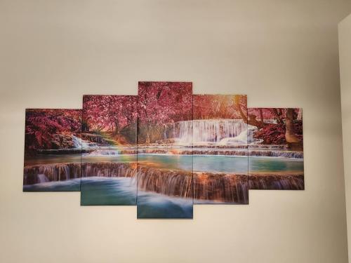 a painting of a waterfall hanging on a wall at Sweet night in bari in Bari