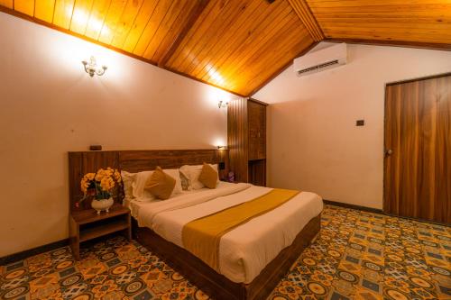 a bedroom with a large bed in a room at Red Button Resort in Mahabaleshwar