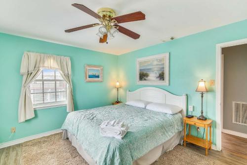 a bedroom with a bed and a ceiling fan at Herons Nest by VTrips in Galveston