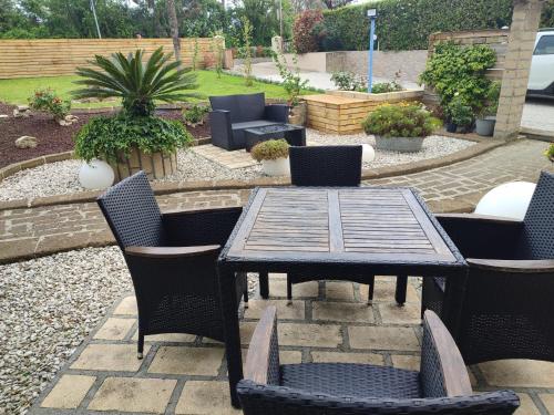 a wooden table and chairs in a garden at Euro Hotel in Tirrenia