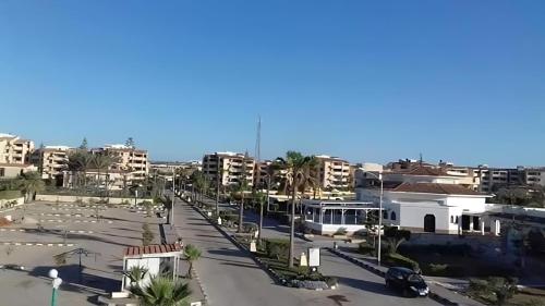 a view of a street in a city with buildings at Villa with Roof, Private Garden and Backyard in North Coast - Families Only فيلا مستقلة الساحل الشمالي - عائلات فقط in Dawwār Abū Maḩrūs