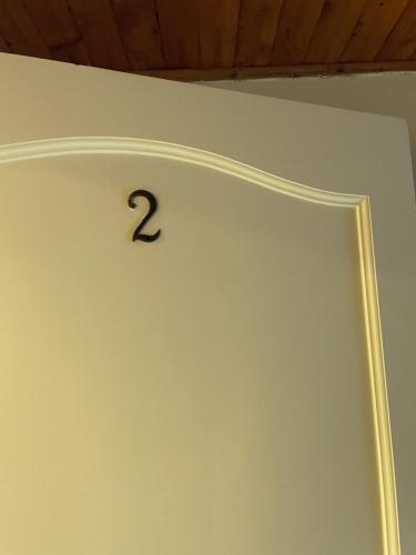 a clock on a wall with the number two on it at Hotel Campestre Villa Mary in Santa Rosa de Cabal