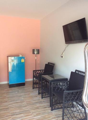 a room with chairs and a flat screen tv at R2 Apartment Service in Nakhon Ratchasima