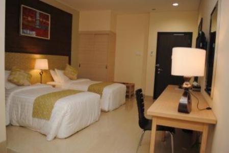 En eller flere senger på et rom på Ria Bintan Golf Club