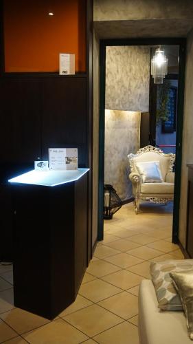 a room with a counter and a couch in a room at HOTEL DEL CORSO in Borgomanero