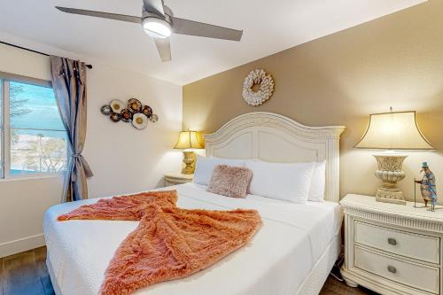 a bedroom with a white bed and a window at Festival and Family Fun Permit# 50369 in Indio