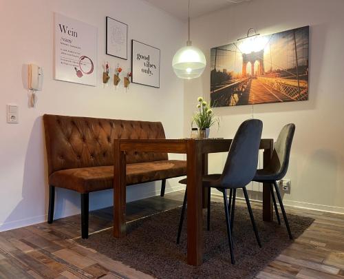 a dining room with a table and two chairs at Living at Saarpartments -Adults Only- 2 Bedrooms, Netflix - Business & Holiday Apartments for Long- and Short term Stay, 3 min to Train Station and Europa Galerie in Saarbrücken