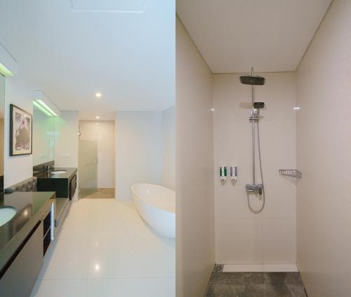 a white bathroom with a tub and a sink at Odika Lovina Villas in Lovina