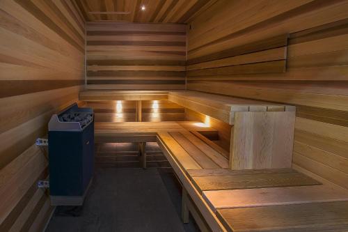 a wooden sauna with a trash can in it at Melbourne Holiday Apartments Flinders Wharf in Melbourne
