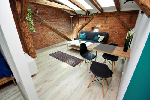 a room with a table and chairs and a couch at Apartamenty na Starym Mieście in Gliwice