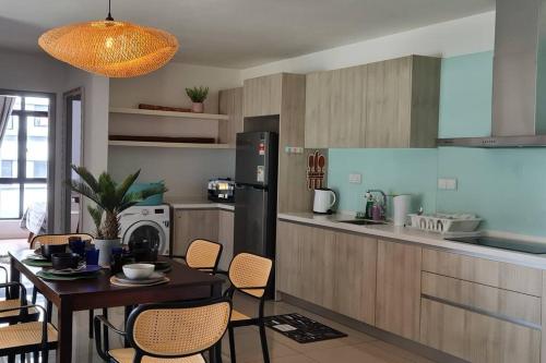 a kitchen with a table and a dining room at BOHO Geniehome 3BR free W-ifi @ Utropolis ShahAlam in Shah Alam