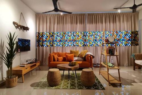 a living room with a couch and a table at BOHO Geniehome 3BR free W-ifi @ Utropolis ShahAlam in Shah Alam