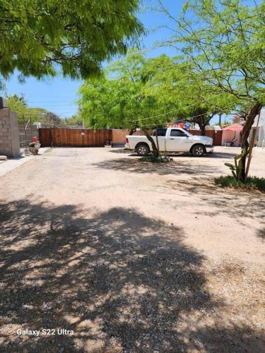a white truck is parked in a driveway at Guest house 2 mins from da beach in Puerto Peñasco