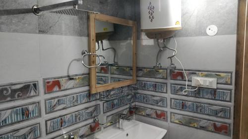 a bathroom with a sink and a mirror at Loghouse at khajjiar lake in Khajjiar 