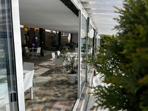 a balcony with a table and chairs and plants at Riviera 990 - Resort & Restaurant in Eşelniţa