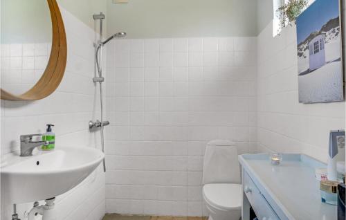 uma casa de banho com um lavatório, um WC e um espelho. em Cozy Home In Rrvig With House Sea View em Rørvig