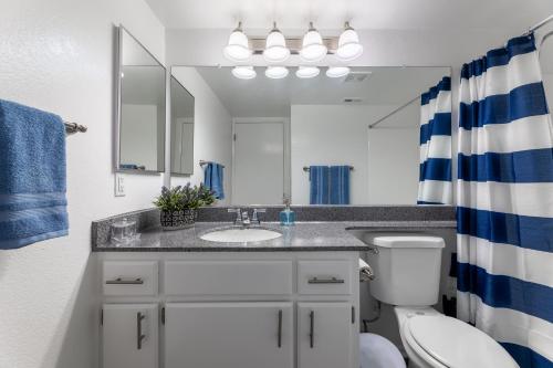 a bathroom with a sink and a toilet and a mirror at "INACTIVE UNBOOKABLE - 5 mins from Disneyland and Convention Center - Your Perfect SoCal Getaway!" in Anaheim