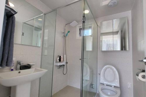 a bathroom with a shower and a toilet and a sink at SunnyVille 90 in Yangpyeong