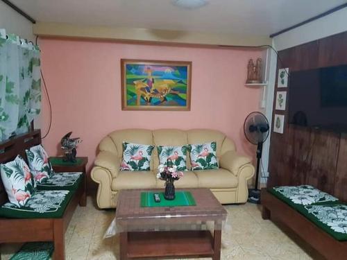 a living room with a couch and a table at Casa Corazon Transient House in Casboran