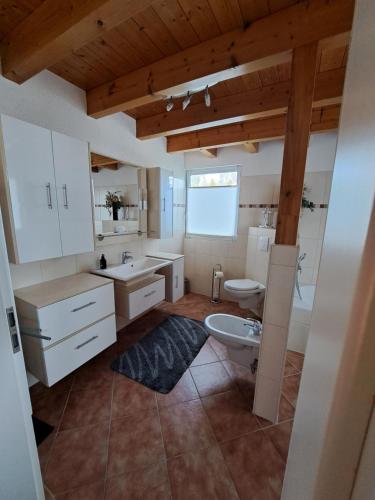 a bathroom with a sink and a toilet at HM - Ferienhaus 3 Deluxe Krombachtalsperre Westerwald exklusive verbrauchte NK in Driedorf