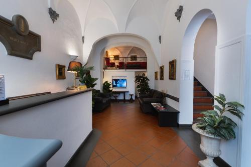 a hallway with a living room with a couch at Hotel Unicorno in Florence