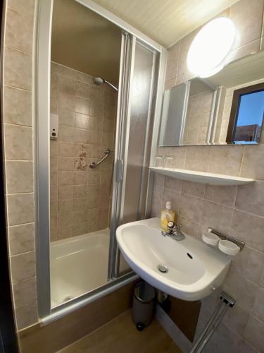 a bathroom with a sink and a shower at Haus Tirol Ehrwald in Ehrwald