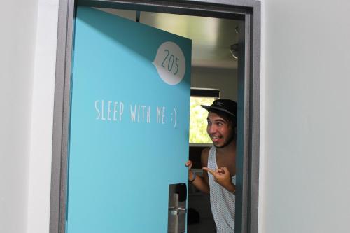 a man standing in front of a mirror at Port Douglas Backpackers in Port Douglas