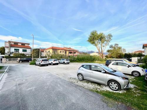 a group of cars parked in a parking lot at Dimora del Viaggiatore in Marina di Carrara