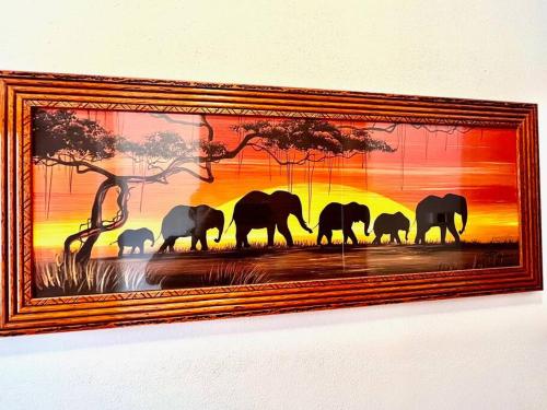 a picture of a herd of elephants in a painting at Dimora del Viaggiatore in Marina di Carrara