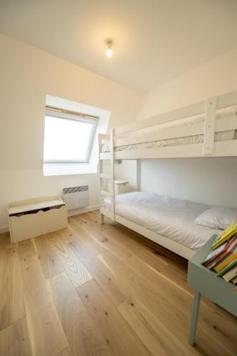 une chambre avec deux lits superposés et une fenêtre dans l'établissement Hyper centre - duplex 73m2 au dernier étage, à Le Touquet-Paris-Plage