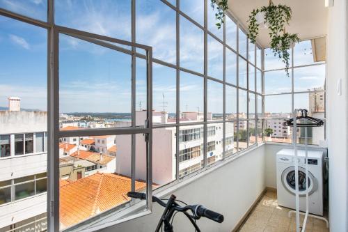 a bike is parked in front of a large window at urban beach sixties in Portimão