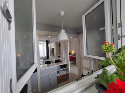 a kitchen with a large window and a living room at APPARTEMENT T2 RIVE DROITE in Brest