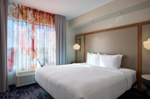 a hotel room with a large bed and a window at Fairfield Inn and Suites by Marriott Winchester in Winchester