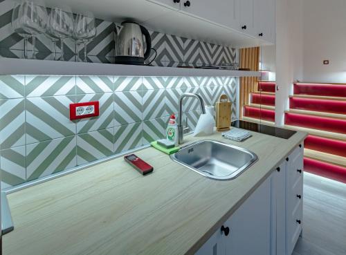 a kitchen with a sink and a counter top at Green Gallery on a Main Square in Zagreb