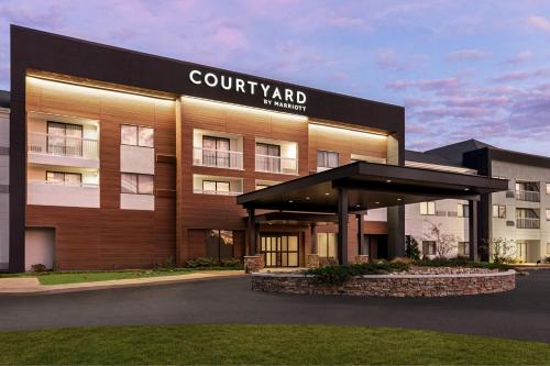 a building with a sign on the front of it at Courtyard Tupelo in Tupelo