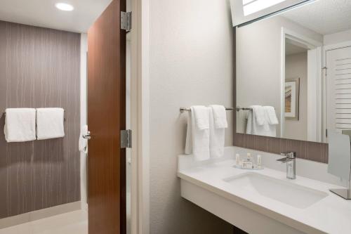 a bathroom with a sink and a mirror at Courtyard Tupelo in Tupelo