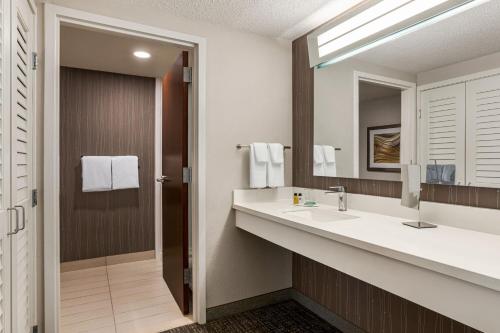 a bathroom with a sink and a mirror at Courtyard Tupelo in Tupelo