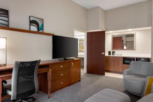 an office with a desk with a flat screen tv at Courtyard Tupelo in Tupelo