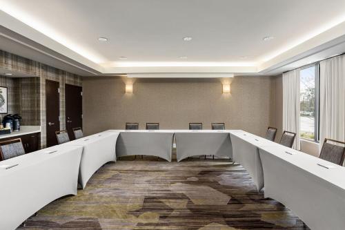 a conference room with a long table and chairs at Courtyard Tupelo in Tupelo