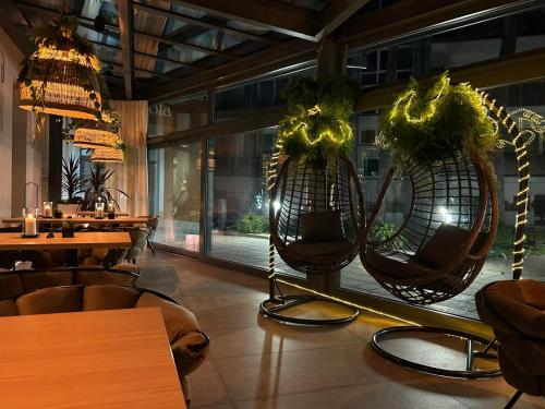 a restaurant with two large baskets with plants in it at Grand Laola Spa in Pobierowo