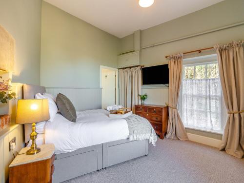 a bedroom with a large bed and a window at The Lodge in Wonastow