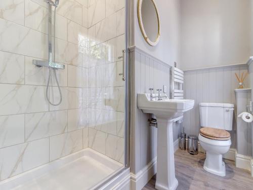 a bathroom with a shower and a toilet and a sink at The Lodge in Wonastow