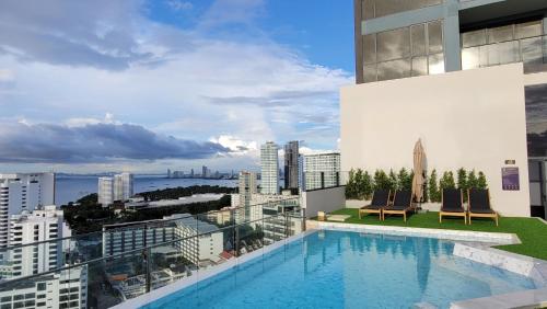 a swimming pool on the roof of a building at Andromeda Seaview Condo Near Beach in Pattaya South