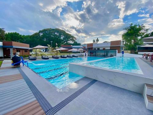 a large swimming pool with blue water at Aurora Villas and Cabin Resort in Clark