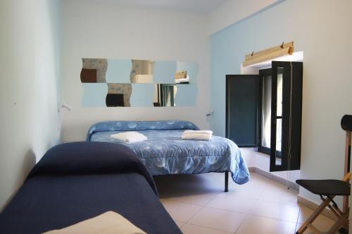 a bedroom with a blue bed and a chair at PALAZZO PELLEGRINO vietri in Vietri sul Mare