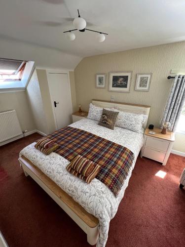 a bedroom with a large bed and a window at Oakbank Farm in Lamlash