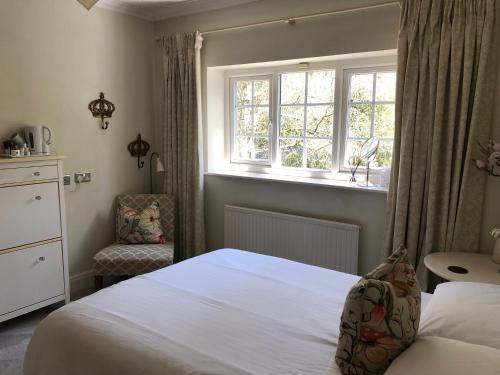 a bedroom with a white bed and a window at Room in Twemlow Green in Goostrey